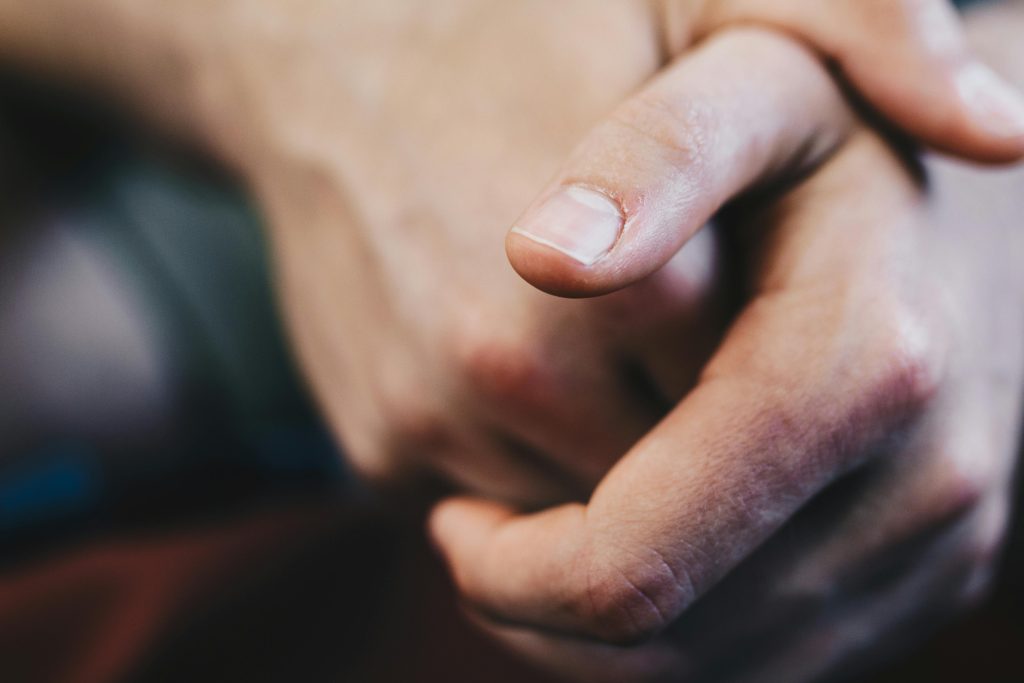 pexels photo 808960 808960 Detailed close-up of a hand with fingers interlocked, creating a contemplative gesture.